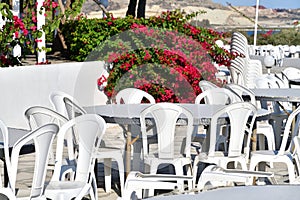 Outdoor cafe with white plastic tables and chairs