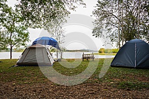 Outdoor camping tent near lake, The cart is between the tents, holiday activities