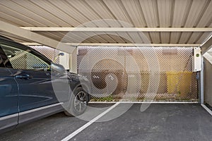 An outdoor car park covered with a tin roof with fast charging stations