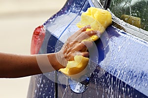 Outdoor car wash with yellow sponge