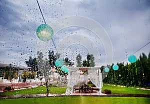 Outdoor ceremony. Decoration of celebrations. Rain through the window