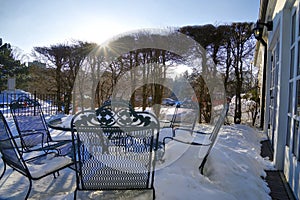 The outdoor chair with snow coving in the winter