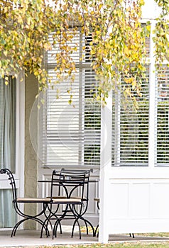 Outdoor Chairs and Table on White Porch