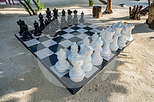 Outdoor Chess Game at Big Chequer Board. Super big size of black and white chess game pieces