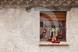 Outdoor christmas decoration. Red balls and garlands on a window