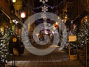 outdoor christmas decorations on a cobblestone street in old quebec city