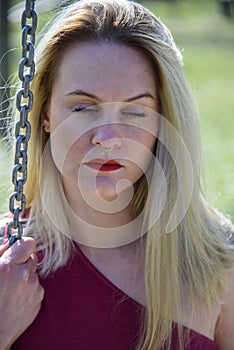 Outdoor close-up of beautiful girl with long blond hair.