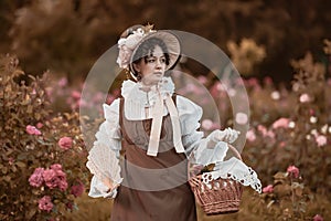 Outdoor close up portrait of beautiful woman wearing wide brim ribbon tie straw hat, vintage dress. Model posing in the blooming