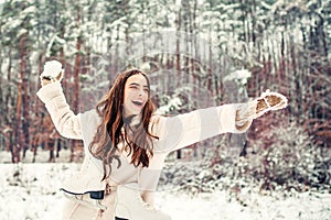 Outdoor close up portrait of excited young beautiful girl snowball fight. Winter woman.