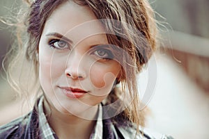 Outdoor close up portrait of young beautiful woman with natural make up