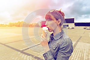 Outdoor closeup fashion portrait of young hipster crazy girl eating ice cream