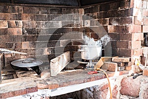 Outdoor cooking area with steaming pot on gas flame