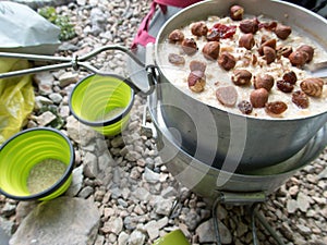Outdoor cooking camping breakfest with porridge