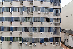 Outdoor cooling system installed on the exterior wall of a modern apartment complex.