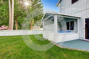 Outdoor covered hot tub in the backyard garden.