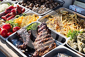 Outdoor Cuisine Culinary Buffet with healthy take away meal - grilled vegetables, fish and meat on the street food culinary market