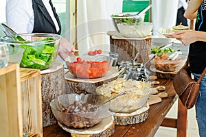 Outdoor Cuisine Culinary salad bar Catering. Group of people in all you can eat. Dining Food Celebration Party Concept. Service at
