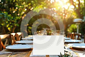 Outdoor dining setup with empty white menu on a rustic wooden table, elegant tableware and nature background. For