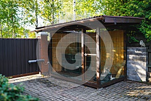 Outdoor dog kennel enclosure on front yard