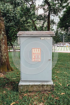 Outdoor electric box with many languages words near Petronas twin towers in Kuala Lumpur, Malaysia