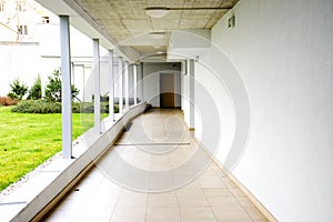 Outdoor empty corridor with garden in the modern office building