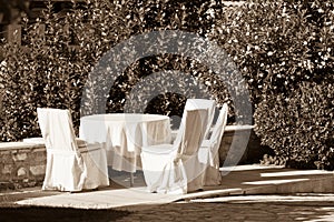 Outdoor empty summer cafe table with chairs