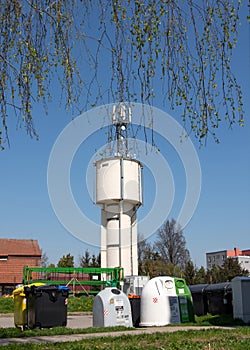 Outdoor environment with eco-friendly bins and retro water tower.