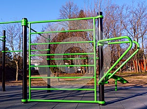 Outdoor exercise park detail. new green color stretching and workout equipment