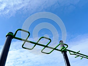 Outdoor exercise park detail. new green color stretching and workout equipment