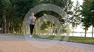 outdoor exercise of sporty man running in park, sprinting