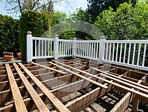 Outdoor exterior wooden cedar deck being remodeled with floor boards being removed