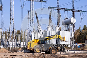 The outdoor extra high voltage power transformer. A high-voltage power electrical substation. Assembly work of power units at the