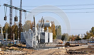 The outdoor extra high voltage power transformer. A high-voltage power electrical substation. Assembly work of power units at the