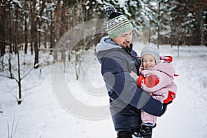 Outdoor family activities for happy winter holidays. Happy father playing with little baby toddler girl daughter in