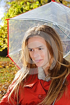 Outdoor fashion close up portrait of young beautiful sensual woman in Autumn park with umbrella