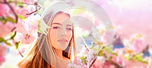 Outdoor fashion photo of beautiful young woman in flowers. Sensual girl on spring blossom background. Beauty romantic