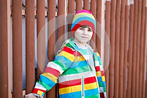 Outdoor fashion portrait of adorable little kid boy wearing colorful clothes. Spring, summer or autumn fashion for boys