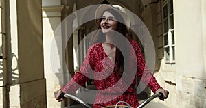Outdoor fashion portrait of elegant lady riding her hipster retro bike in vintage stylish maxi skirt warm cardigan and