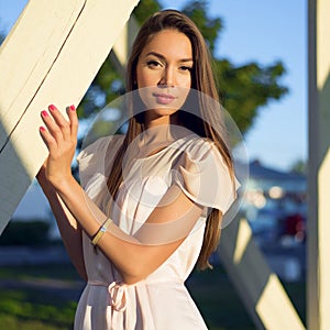 Outdoor fashion portrait glamor sensual stylish young woman wearing a summer dress sweet , brunette girl. Pink , red