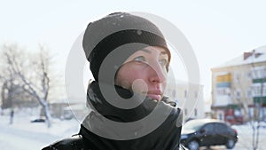 Outdoor fashion portrait of pretty young woman in winter park. beautiful woman walking outdoors under snowfall. winter
