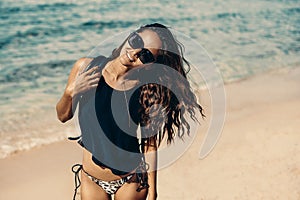 Outdoor fashion portrait of lady posing at the beach