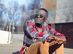 Outdoor fashion portrait of stylish young african man