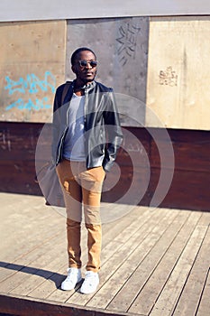 Outdoor fashion portrait of stylish young african man