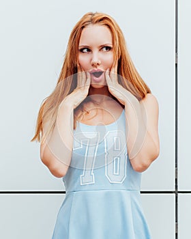 Outdoor fashion portrait of stylish young woman having fun, emotional face , laughing. Urban city street style. Spring or fall out