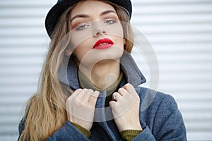 Outdoor fashion portrait of young beautiful fashionable woman wearing stylish accessories.vintage hat,looking at camera