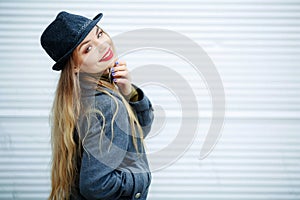 Outdoor fashion portrait of young beautiful fashionable woman wearing stylish accessories.vintage hat,looking at camera