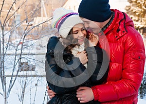 Outdoor fashion portrait of young sensual couple in cold winter wather.