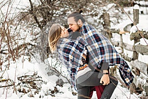 Outdoor fashion portrait of young sensual couple in cold winter weather. love and kiss