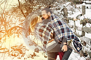 Outdoor fashion portrait of young sensual couple in cold winter weather. love and kiss