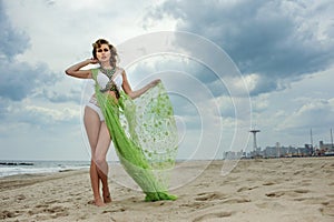 Outdoor fashion summer photo of beautiful slim woman with perfect body in luxury design bikini.